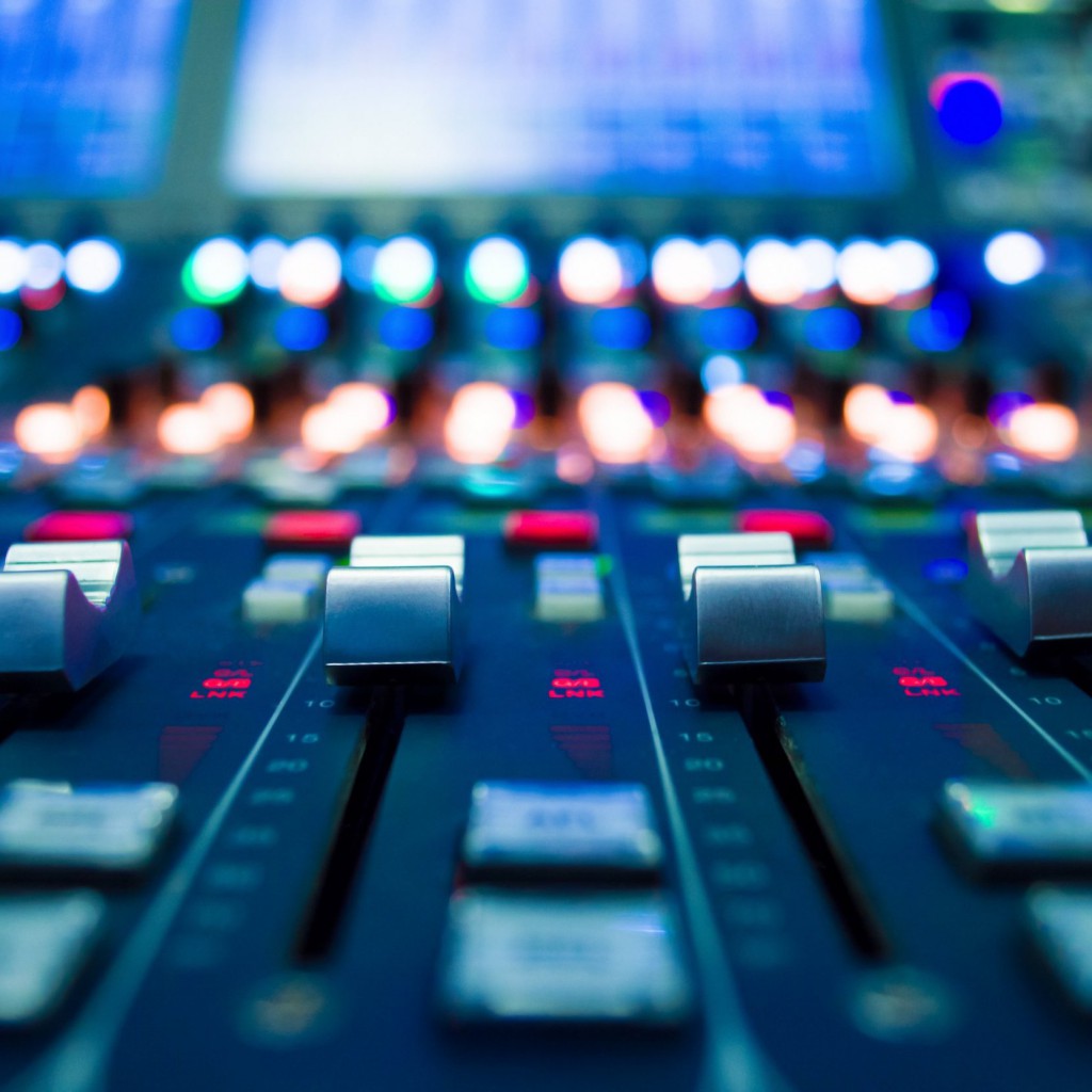 detail of a music mixer in studio dj working for new tracks music production with editing tools