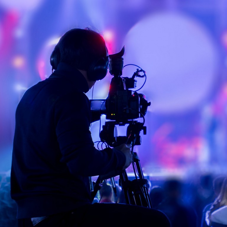 The filmmaker is recording and broadcasting live concerts on camcorders. Professional Video Recording Business